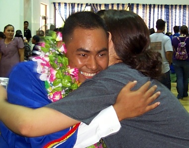 Valedictorian Samuel Yiluy being congratulated.